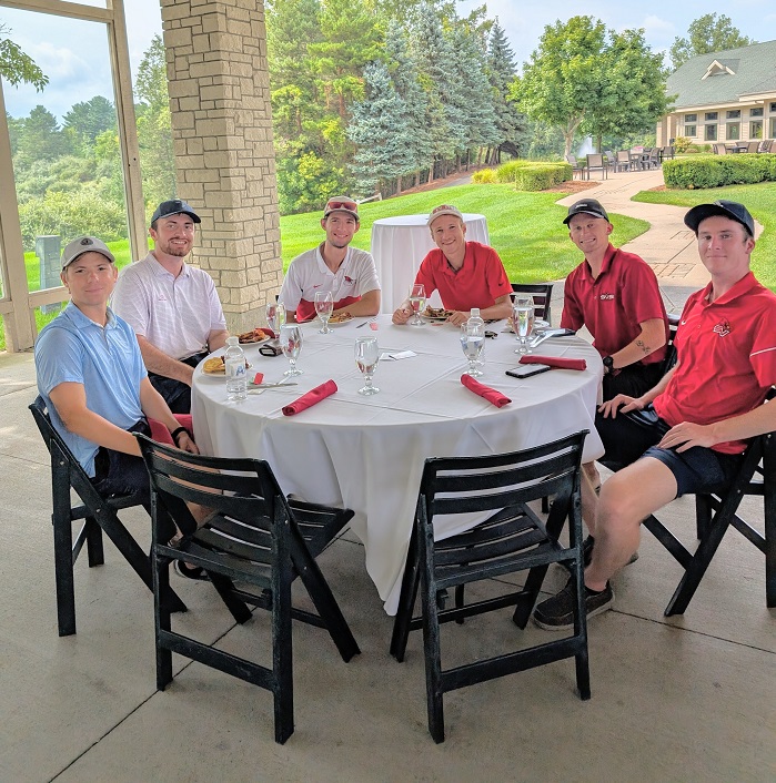 group of people enjoying the reception after 18 holes of golf